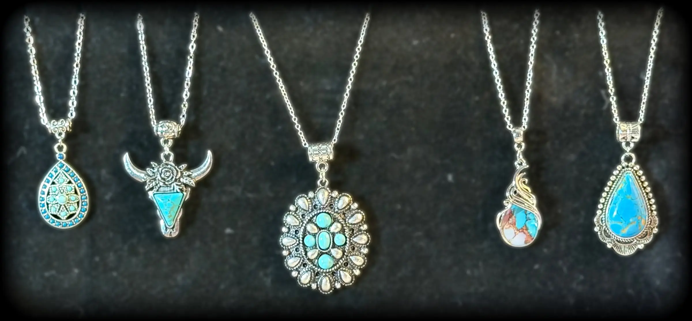 Five turquoise pendants: a mosaic teardrop, a rose longhorn, a turquoise cluster oval, a wire-wrapped stone and a turquoise teardrop