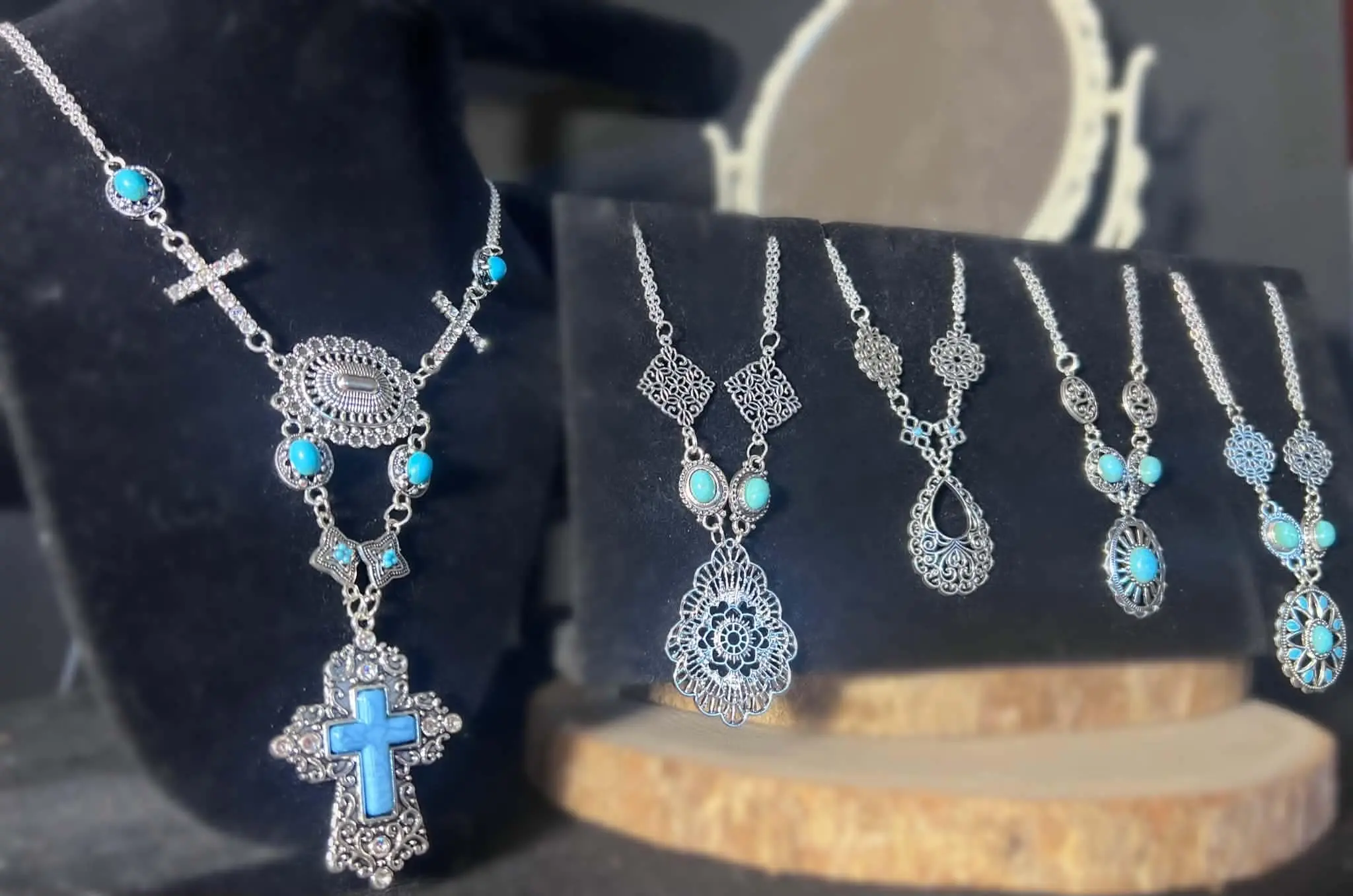 Handmade filigree and turquoise necklaces displayed on black velvet